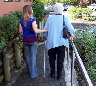 elderly person being assisted to walk